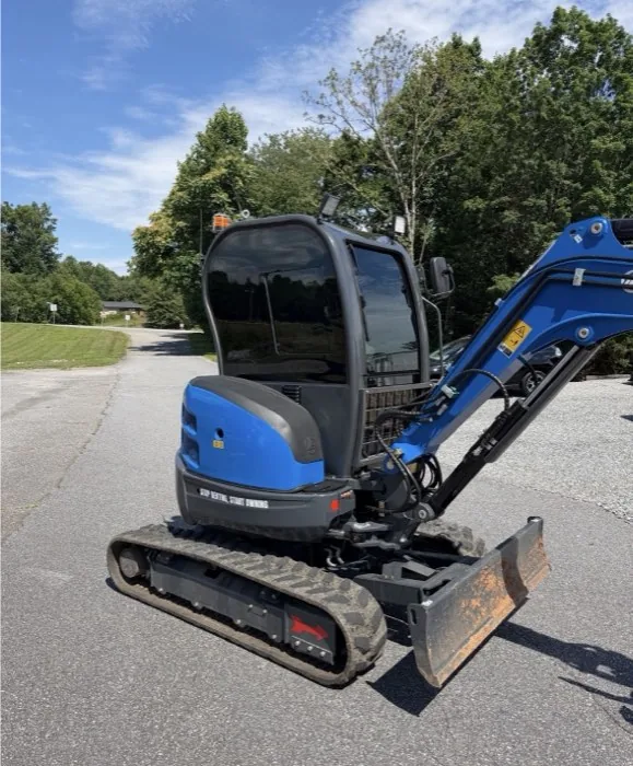 Blue mini excavator with tinted cab glass