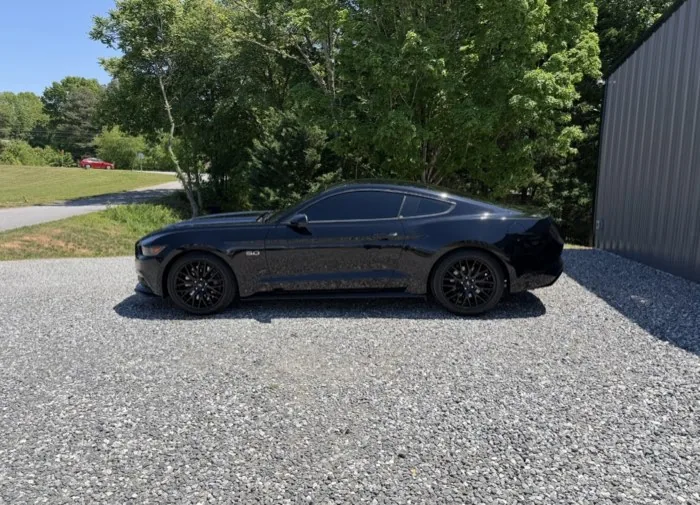 Black Ford Mustang GT with tinted windows